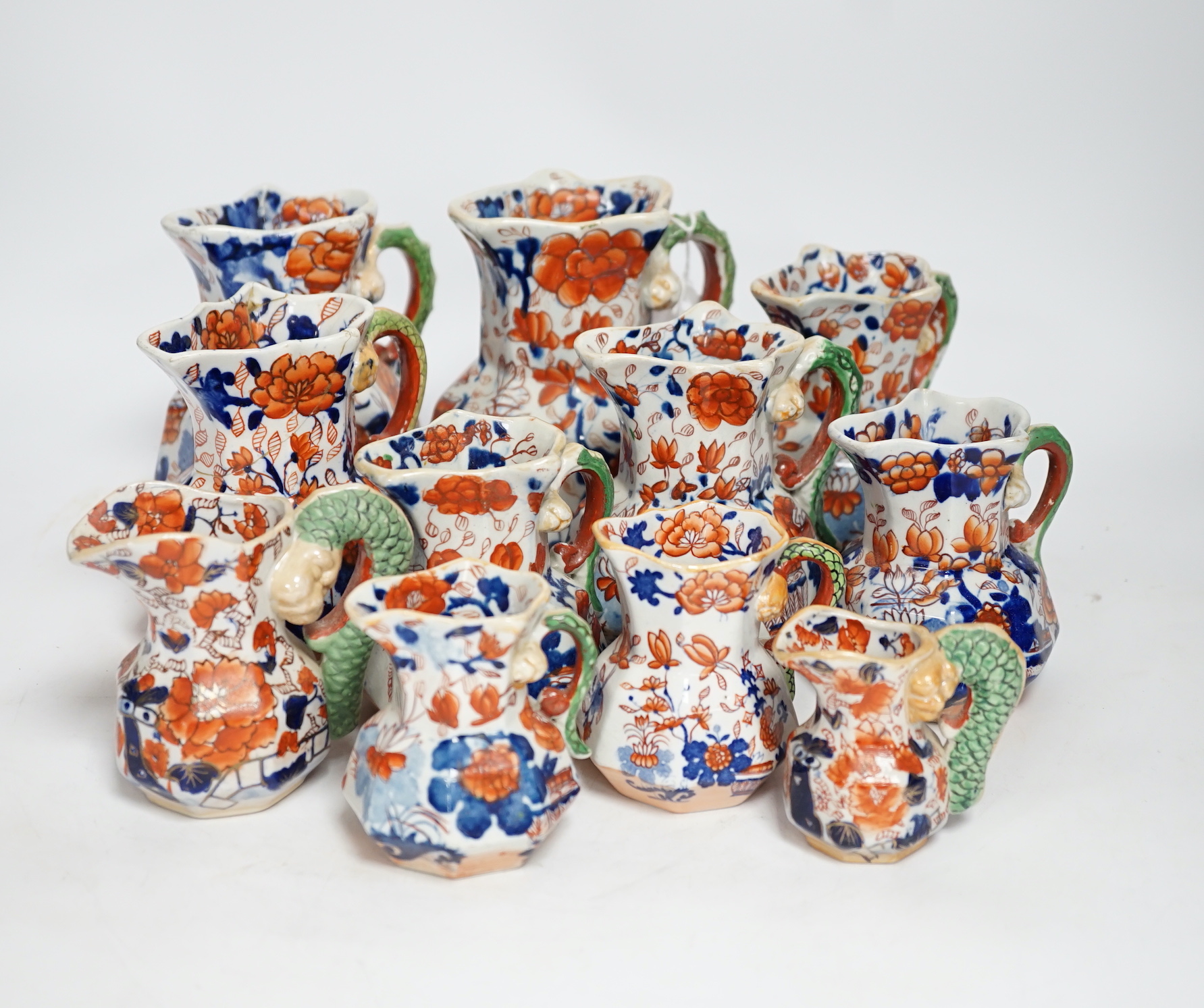 Eleven graduated Masons ironstone jugs, largest 13cm high